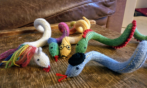A collection of hand knitted snakes.