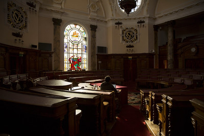 Looking towards the centre of a circular room with raked seating.